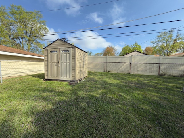 view of yard with an outbuilding, fence, and a shed