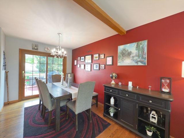 dining room with baseboards, beamed ceiling, a chandelier, and light wood-style flooring