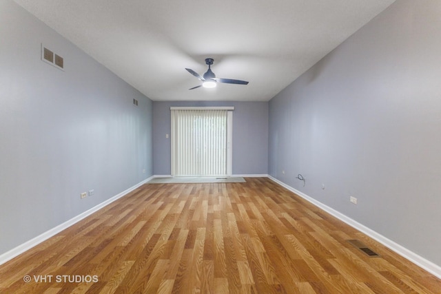 spare room with a ceiling fan and light wood-style flooring