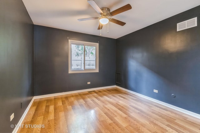spare room featuring light wood-type flooring and a ceiling fan