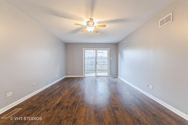 unfurnished room with a ceiling fan and dark wood-type flooring