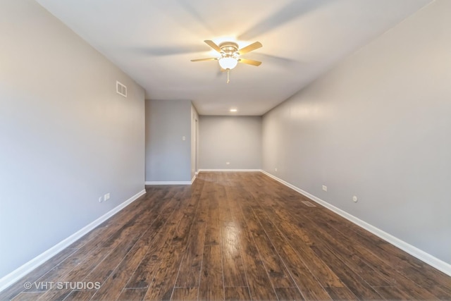 spare room with a ceiling fan and dark wood finished floors