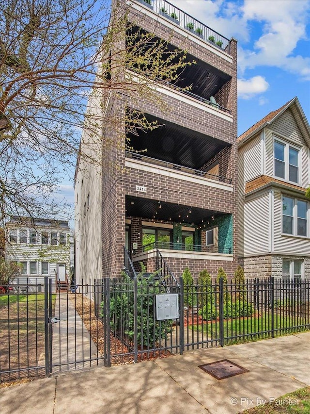 view of property featuring a fenced front yard and stairway