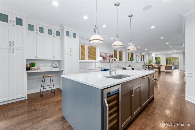 kitchen with recessed lighting, white cabinetry, a sink, and wine cooler
