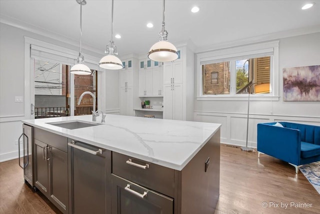 kitchen featuring dark wood finished floors, a sink, and a decorative wall