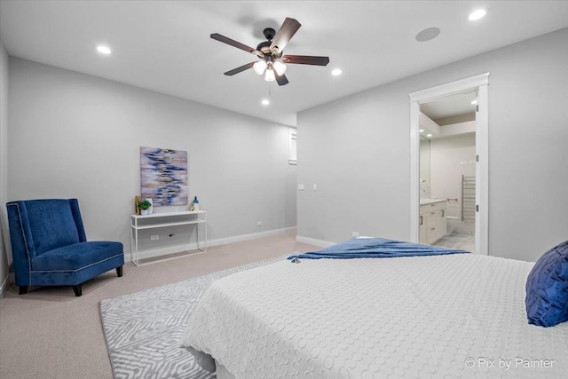bedroom featuring baseboards, light carpet, recessed lighting, and connected bathroom