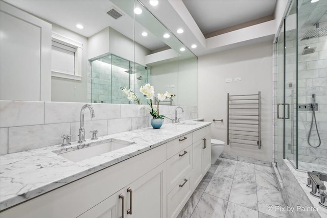 full bath with a sink, marble finish floor, recessed lighting, and visible vents