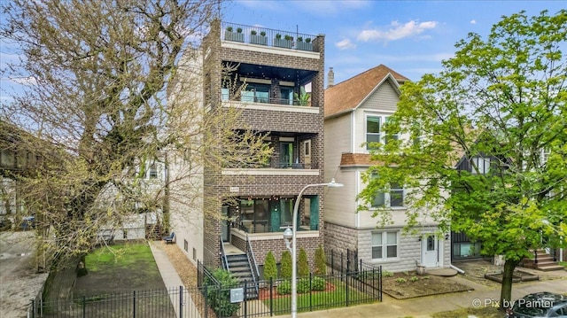 exterior space featuring a fenced front yard and stairs