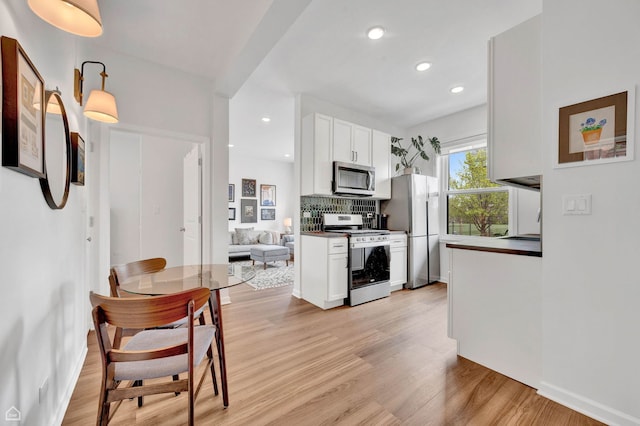 6102 S Kimbark Ave Unit 1W, Chicago, IL 60637 - kitchen featuring recessed lighting, white cabinetry, tasteful backsplash, light wood finished floors, and stainless steel appliances