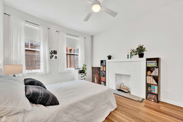 6102 S Kimbark Ave Unit 1W, Chicago, IL 60637 - bedroom with baseboards, a ceiling fan, wood finished floors, and a fireplace