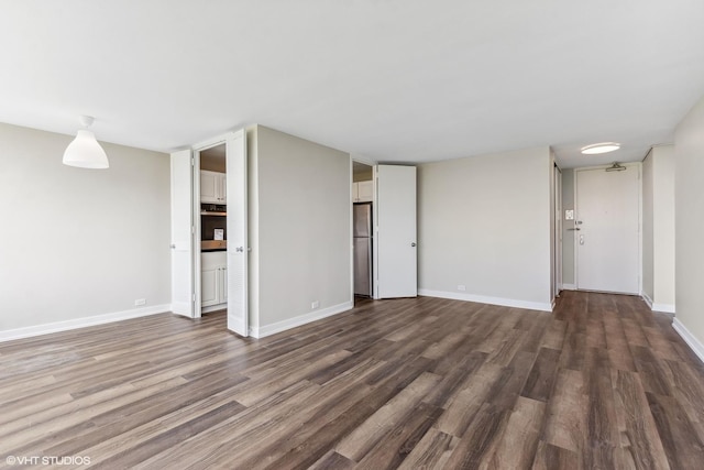 4800 S Chicago Beach Dr Unit 1005N, Chicago, IL 60615 - unfurnished living room with baseboards and dark wood-style floors