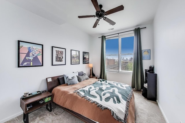 bedroom with baseboards, ceiling fan, light carpet, and visible vents
