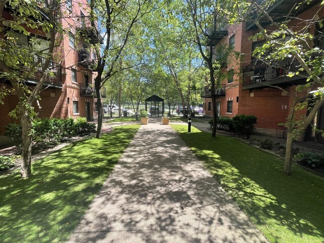 view of home's community with a yard