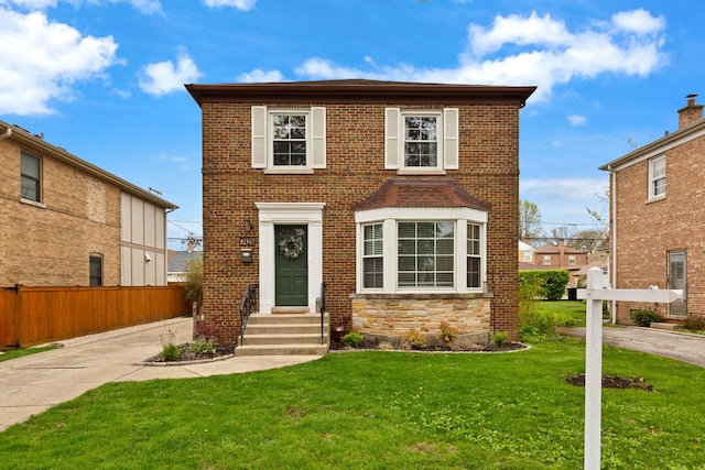7428 N Odell Ave, Chicago, IL 60631 - traditional-style house featuring entry steps, a front lawn, fence, and brick siding