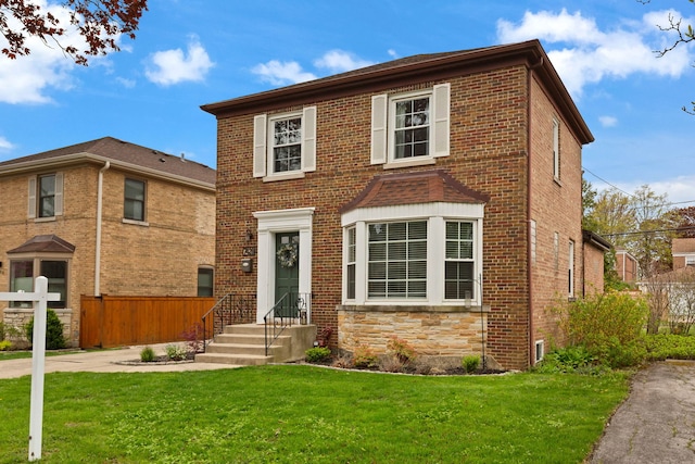 7428 N Odell Ave, Chicago, IL 60631 - traditional-style house featuring a front yard, brick siding, and fence