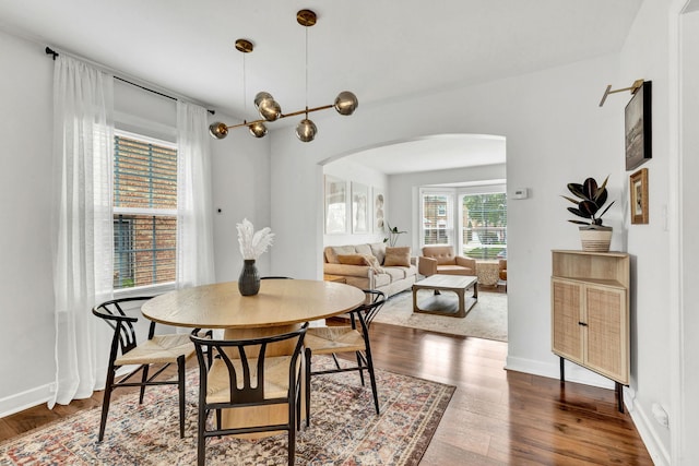 7428 N Odell Ave, Chicago, IL 60631 - dining space with dark wood-style flooring, baseboards, and arched walkways