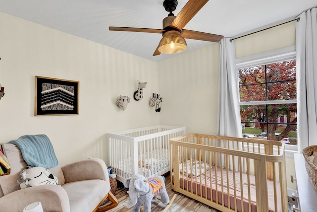 7428 N Odell Ave, Chicago, IL 60631 - bedroom featuring a crib, wood finished floors, and ceiling fan
