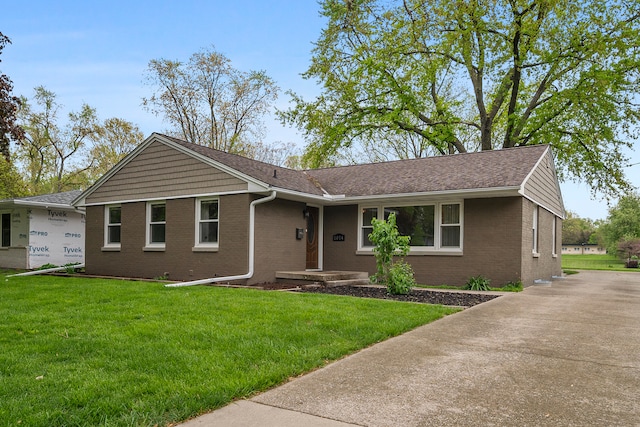 single story home featuring a front yard and brick siding