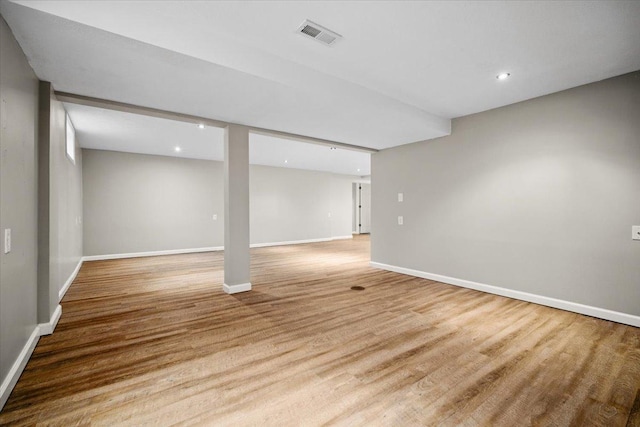 finished below grade area with recessed lighting, baseboards, and light wood-style flooring