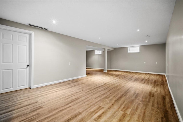 basement with recessed lighting, baseboards, visible vents, and light wood-style floors