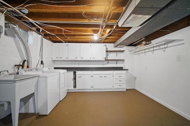 laundry area with baseboards, cabinet space, and washing machine and clothes dryer