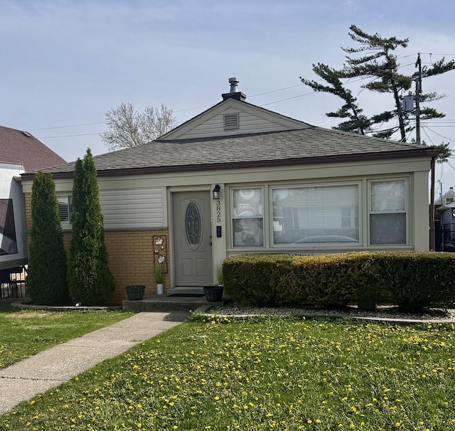 3825 W Pippin St, Chicago, IL 60652 - view of front of house featuring a shingled roof, brick siding, and a front yard