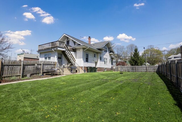 111 E Palatine Rd, Palatine, IL 60067 - rear view of property featuring a chimney, a wooden deck, stairway, a fenced backyard, and a yard