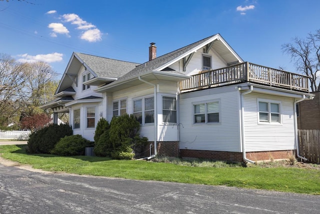 111 E Palatine Rd, Palatine, IL 60067 - view of side of property with a shingled roof, fence, a balcony, and a chimney