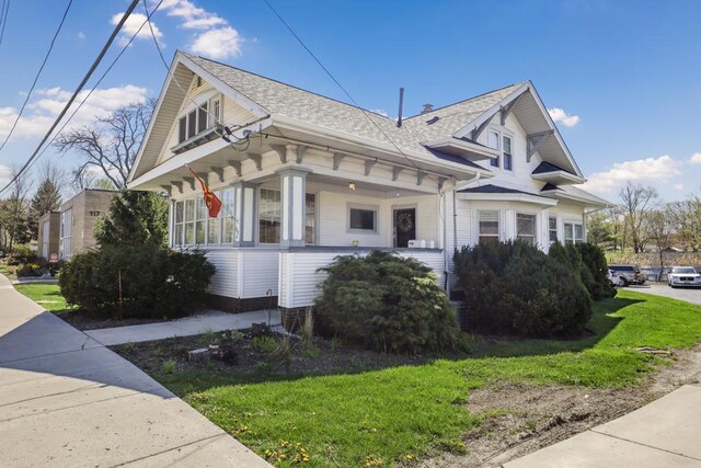 111 E Palatine Rd, Palatine, IL 60067 - view of property exterior with a porch, a shingled roof, and a yard