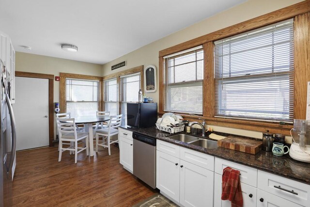 111 E Palatine Rd, Palatine, IL 60067 - kitchen featuring dark wood-style floors, white cabinetry, a sink, dark stone countertops, and stainless steel appliances