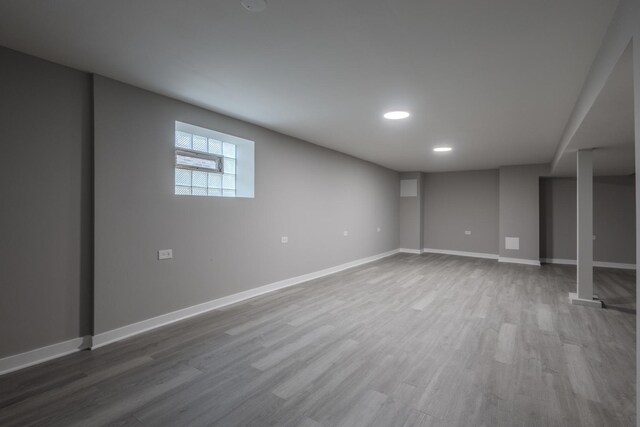 below grade area featuring recessed lighting, baseboards, and wood finished floors