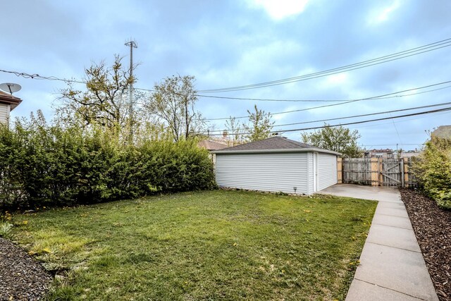 view of yard featuring an outdoor structure, a gate, and fence
