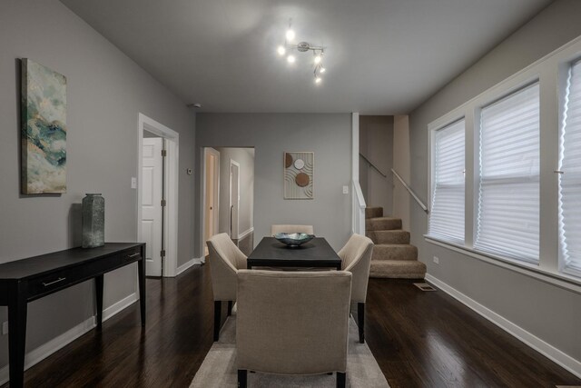 dining room with baseboards, dark wood-style flooring, stairs, and visible vents