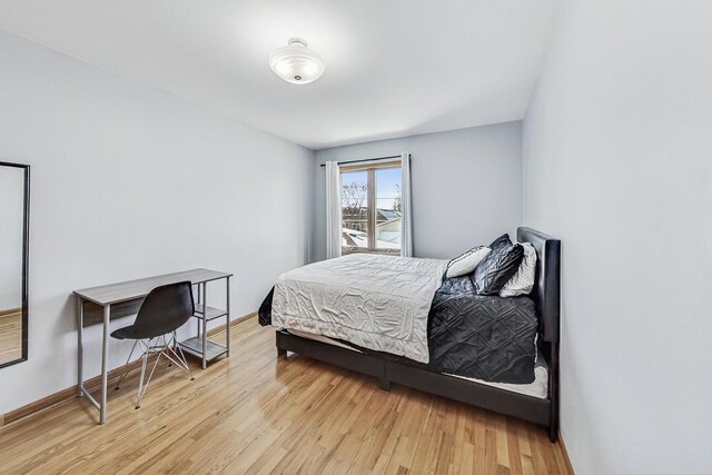 bedroom featuring baseboards and light wood-style flooring