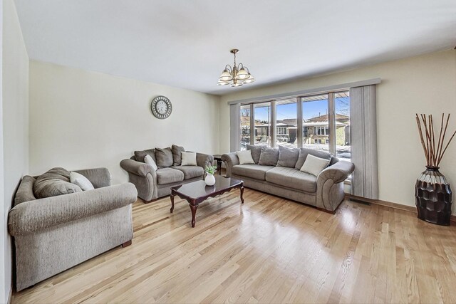 living room with a chandelier and light wood-style floors