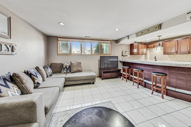 living area featuring light tile patterned floors, recessed lighting, and visible vents