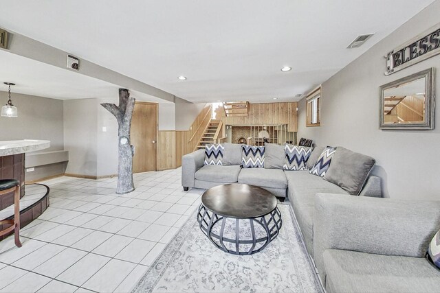 living room with visible vents, light tile patterned flooring, baseboards, stairway, and recessed lighting