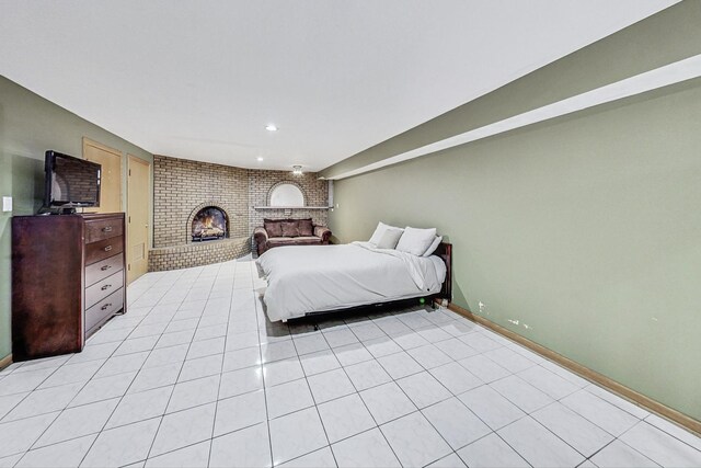 bedroom featuring baseboards, recessed lighting, a brick fireplace, and light tile patterned floors