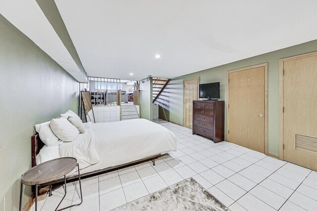 bedroom with recessed lighting and light tile patterned floors