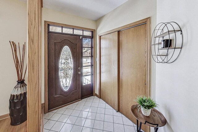 entrance foyer featuring light tile patterned flooring and a healthy amount of sunlight
