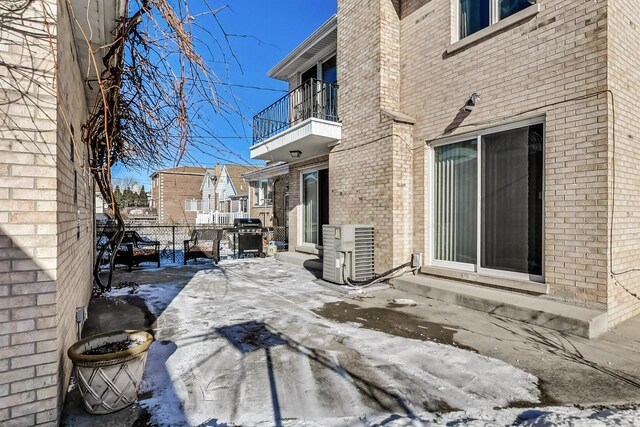 exterior space with ac unit, fence, a balcony, and entry steps