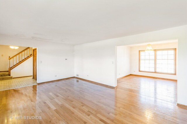 2339 N James Ct, Arlington Heights, IL 60004 - unfurnished room featuring light wood-type flooring, stairway, and baseboards