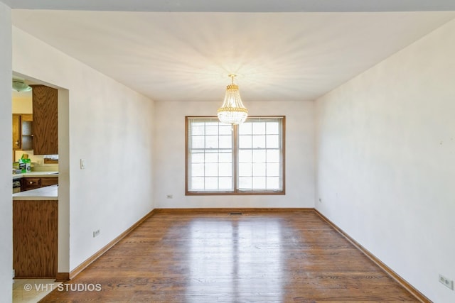 2339 N James Ct, Arlington Heights, IL 60004 - unfurnished room with a chandelier, wood finished floors, and baseboards