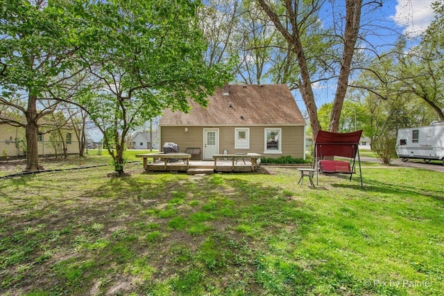 2381 Elm Rd, West Chicago, IL 60185 - rear view of house with a wooden deck and a lawn