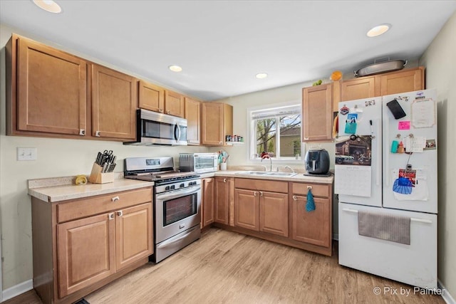 2381 Elm Rd, West Chicago, IL 60185 - kitchen featuring stainless steel appliances, a sink, light wood finished floors, light countertops, and recessed lighting
