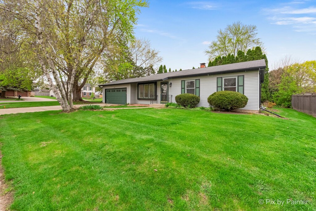 5210 Abbey Dr, Mchenry, IL 60050 - single story home with driveway, a chimney, a front yard, a garage, and fence