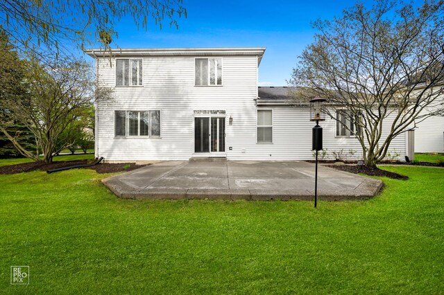 back of house with a yard and a patio area