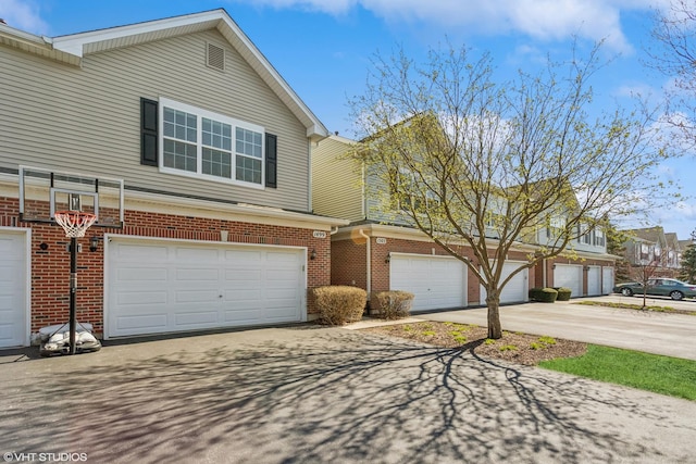 1499 Shagbark Dr, Bolingbrook, IL 60490 - view of front of home featuring brick siding, an attached garage, and aphalt driveway