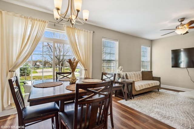 1499 Shagbark Dr, Bolingbrook, IL 60490 - dining space with baseboards, ceiling fan with notable chandelier, a healthy amount of sunlight, and dark wood-style floors