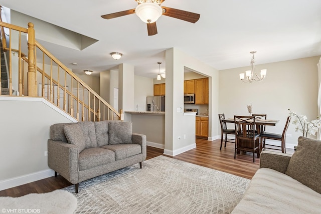 1499 Shagbark Dr, Bolingbrook, IL 60490 - living room with baseboards, stairs, ceiling fan with notable chandelier, and dark wood-type flooring